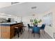 Open dining area adjacent to the kitchen and breakfast bar, with contemporary lighting and decor at 450 Treasure Isle Causeway # 212, Treasure Island, FL 33706