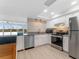 Bright modern kitchen with stainless steel appliances, white cabinets and a peninsula opening up to the living spaces at 450 Treasure Isle Causeway # 212, Treasure Island, FL 33706
