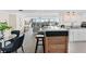 Bright open kitchen with a breakfast bar, stainless steel appliances, and views of the living area and outside at 450 Treasure Isle Causeway # 212, Treasure Island, FL 33706