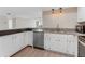 Bright kitchen features white cabinetry, updated stainless steel appliances, and pendant lighting at 450 Treasure Isle Causeway # 212, Treasure Island, FL 33706