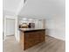Modern kitchen with a breakfast bar with granite countertops and wood accents with stainless steel appliances and white cabinets at 450 Treasure Isle Causeway # 212, Treasure Island, FL 33706