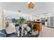 A well lit living area featuring an open kitchen design, a dining area and plenty of windows at 450 Treasure Isle Causeway # 212, Treasure Island, FL 33706