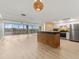Spacious open-concept living area with natural light, views from the sliding glass doors, and seamless flow to the kitchen at 450 Treasure Isle Causeway # 212, Treasure Island, FL 33706