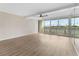Empty living room with neutral walls, light-colored flooring, and an abundance of natural light at 450 Treasure Isle Causeway # 212, Treasure Island, FL 33706