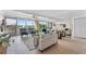Cozy living room boasts large windows with marina views, neutral furnishings, and stylish decor at 450 Treasure Isle Causeway # 212, Treasure Island, FL 33706