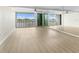 Bright living room with water views, wood floors, ceiling fan, and a mirrored wall at 450 Treasure Isle Causeway # 212, Treasure Island, FL 33706
