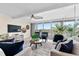 Bright living room with waterfront views through sliding glass doors, creating a serene and inviting atmosphere at 450 Treasure Isle Causeway # 212, Treasure Island, FL 33706