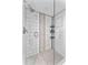 Modern walk-in shower with white subway tile, decorative accents, and glass door at 450 Treasure Isle Causeway # 212, Treasure Island, FL 33706