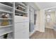 Organized walk-in closet with built-in shelving, drawers, and hanging rods at 450 Treasure Isle Causeway # 212, Treasure Island, FL 33706