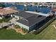 Aerial view of the home, showcasing the roof, landscaped yard, and waterfront location at 5133 Glenn Dr, New Port Richey, FL 34652