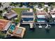 Aerial view of waterfront home with pool, dock, and boat lift at 5133 Glenn Dr, New Port Richey, FL 34652