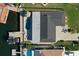 Aerial view of home featuring pool, tiki hut, dock and boat lift at 5133 Glenn Dr, New Port Richey, FL 34652