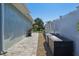 Side yard with pavers and rock provides access to backyard oasis with storage options at 5133 Glenn Dr, New Port Richey, FL 34652