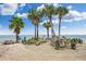 Idyllic beach scene featuring swaying palm trees, cozy seating, and breathtaking ocean views at 5133 Glenn Dr, New Port Richey, FL 34652