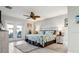 Cozy bedroom features white plank accent wall, ceiling fan, and access to outdoor area at 5133 Glenn Dr, New Port Richey, FL 34652