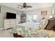 Stylish bedroom boasts plank accent wall, ceiling fan, and sliding doors to a patio at 5133 Glenn Dr, New Port Richey, FL 34652