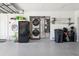 Spacious garage features epoxy flooring, laundry area, refrigerator and ample storage for recreational items at 5133 Glenn Dr, New Port Richey, FL 34652