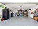 Large garage features epoxy flooring, storage cabinets, shelves and work bench with plenty of open space at 5133 Glenn Dr, New Port Richey, FL 34652