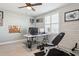 Well-lit home office with desk, chair, and exercise equipment, offering a versatile workspace at 5133 Glenn Dr, New Port Richey, FL 34652
