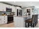 Kitchen features white cabinets, stainless steel appliances, and a large center island with bar seating at 5133 Glenn Dr, New Port Richey, FL 34652