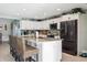 Open kitchen with white cabinetry, stainless steel appliances, and a spacious island with barstools at 5133 Glenn Dr, New Port Richey, FL 34652