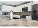 Gorgeous kitchen features white cabinetry, granite countertops, tile backsplash, and modern appliances at 5133 Glenn Dr, New Port Richey, FL 34652