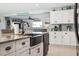 Stylish kitchen features white cabinets, stone countertops, stainless appliances, and a large farmhouse sink at 5133 Glenn Dr, New Port Richey, FL 34652