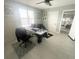Bright home office features modern monitors, a ceiling fan, neutral paint and decor for a productive work-from-home environment at 5133 Glenn Dr, New Port Richey, FL 34652