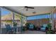 Relaxing screened-in patio with comfortable seating, and lush plants providing an inviting outdoor space at 5133 Glenn Dr, New Port Richey, FL 34652