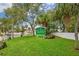 Entrance to Gulf Harbors Beach Club featuring lush lawn and mature trees at 5133 Glenn Dr, New Port Richey, FL 34652