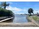 Scenic waterfront view with a boat ramp and serene canal leading to open waters at 5133 Glenn Dr, New Port Richey, FL 34652