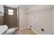 Practical bathroom featuring tile flooring, shower stall, and overhead shelving at 5720 Mockingbird Dr, New Port Richey, FL 34652
