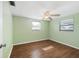Bedroom with hardwood floors, ceiling fan and natural light at 5720 Mockingbird Dr, New Port Richey, FL 34652
