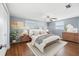 Light-filled main bedroom boasts ample natural light, hardwood floors, and neutral walls at 5720 Mockingbird Dr, New Port Richey, FL 34652
