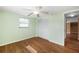 Bedroom has hardwood floors, ceiling fan and a closet at 5720 Mockingbird Dr, New Port Richey, FL 34652