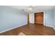 Bedroom features a ceiling fan, closet, and hardwood floors at 5720 Mockingbird Dr, New Port Richey, FL 34652