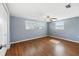Spacious bedroom featuring neutral walls, fan and hardwood flooring at 5720 Mockingbird Dr, New Port Richey, FL 34652