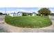 Corner lot showcasing a spacious green lawn and white fence, offering privacy and a park-like setting at 5720 Mockingbird Dr, New Port Richey, FL 34652