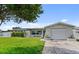 Charming single-story home featuring a well-manicured lawn and attached garage, perfect for comfortable living at 5720 Mockingbird Dr, New Port Richey, FL 34652