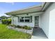 Inviting front entrance with gray trim, decorative planter boxes, and a screen door for fresh air at 5720 Mockingbird Dr, New Port Richey, FL 34652