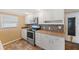 Well-lit kitchen features stainless steel appliances, ample cabinet space, and stylish backsplash at 5720 Mockingbird Dr, New Port Richey, FL 34652