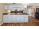 Spacious kitchen with white cabinets, stainless appliances, and mosaic tile backsplash at 5720 Mockingbird Dr, New Port Richey, FL 34652