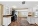Kitchen with tile floors, white cabinets and stainless steel appliances at 5720 Mockingbird Dr, New Port Richey, FL 34652