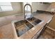 Close-up of a double basin stainless steel kitchen sink with modern faucet and countertop at 5720 Mockingbird Dr, New Port Richey, FL 34652