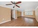 Spacious living area with smooth floors, neutral walls, ceiling fan and an entry doorway at 5720 Mockingbird Dr, New Port Richey, FL 34652