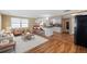 Open-concept living room with kitchen, tile flooring, and abundant natural light at 5720 Mockingbird Dr, New Port Richey, FL 34652