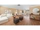 Stylishly furnished living area with an open layout flowing into the dining space, perfect for entertaining at 5720 Mockingbird Dr, New Port Richey, FL 34652