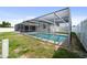 Outdoor pool with screened enclosure at 5720 Mockingbird Dr, New Port Richey, FL 34652