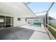 Screened in patio area with in-ground pool and lounging space at 5720 Mockingbird Dr, New Port Richey, FL 34652