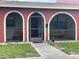 Charming front entrance featuring arched openings and a secure screen door at 6446 71St N St, Pinellas Park, FL 33781